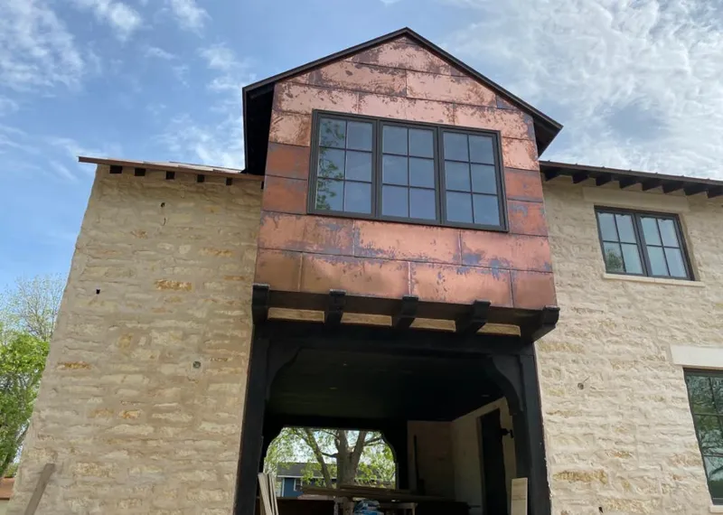 Copper metal panel facade on a stone building for Roof Repair in Moapa Valley