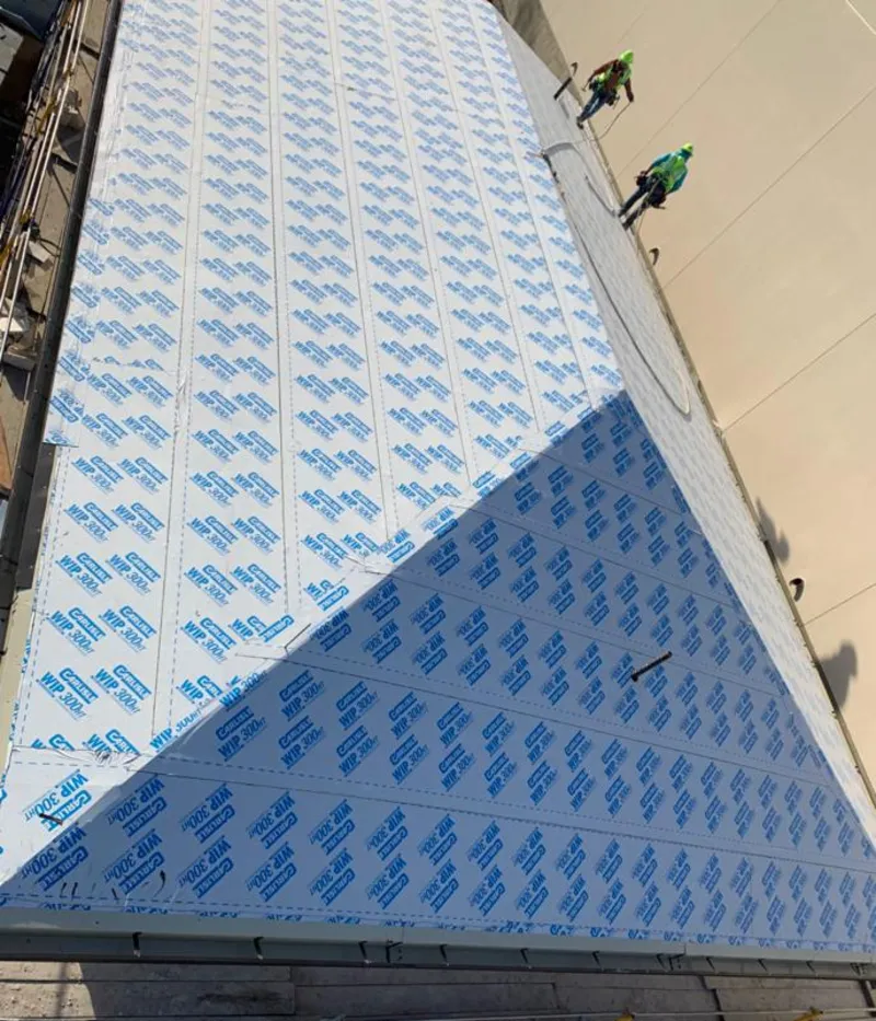 Professional roofers installing underlayment on a metal roof in Moapa Valley